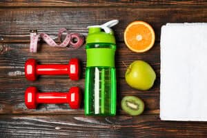 Flat lay composition with healthy lifestyle accessories on wooden background.
